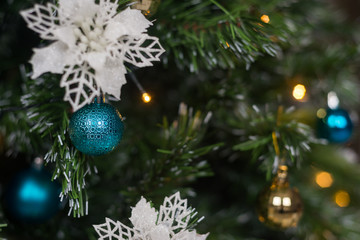 Artificial decorated Christmas tree with balls, ornaments and lights. Festive background for promotion. .