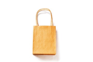 Brown shopping bag in craft paper isolated on a white background. Mockup