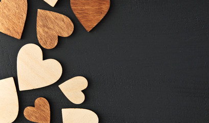 Many wooden hearts on the wooden table