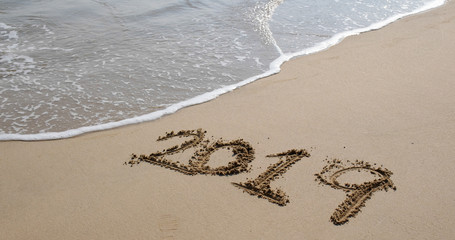 Number 2019 on sandy beach for new year concept