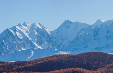 Snow-capped mountain peaks in the daylight. Traveling in the mountains, climbing.