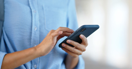 Close up of woman use of mobile phone in city