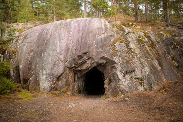 Black hole in rock wall, entrance to the cave in Spro, old mineral mine. Nesodden Norway....