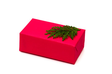Red Christmas gift box decorated with fir tree branch on a white background. Christmas, New Year,...