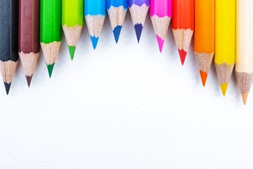 Top view of colourful crayons or colour pencil set in range isolated on white paper background.Education,Business office and Arts Concept.Copy space empty blank for text.Back to school