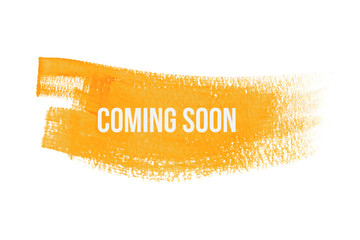 Coming soon on yellow paint background, isolated on white. Advertising banner concept.