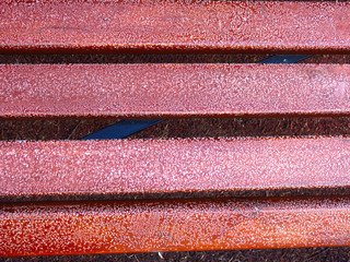 texture of brown and red wooden planks with a touch of frost