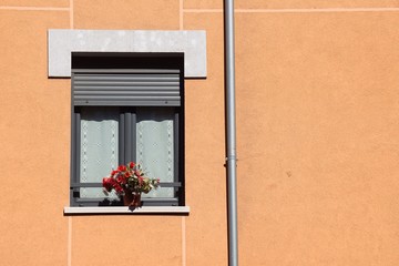 Fototapeta na wymiar window on the orange facade of the house in Bilbao city Spain