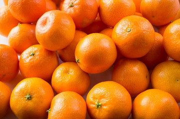 Top view. Fresh tangerines. Ripe and tasty mandarins. Clementines. Background tangerines.