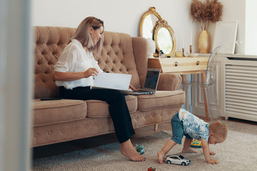 Beautiful business woman working at home. Multi-tasking, freelance and motherhood concept