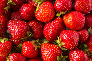 Background of fresh strawberries. Ripe strawberries. Ripe berries close-up. Various fresh summer berries. Background of red berries.