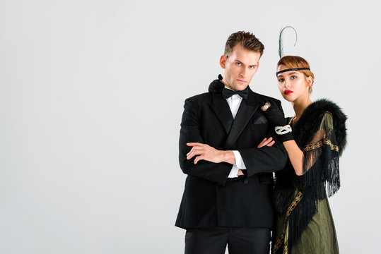 handsome man in suit standing with aristocratic woman isolated on white