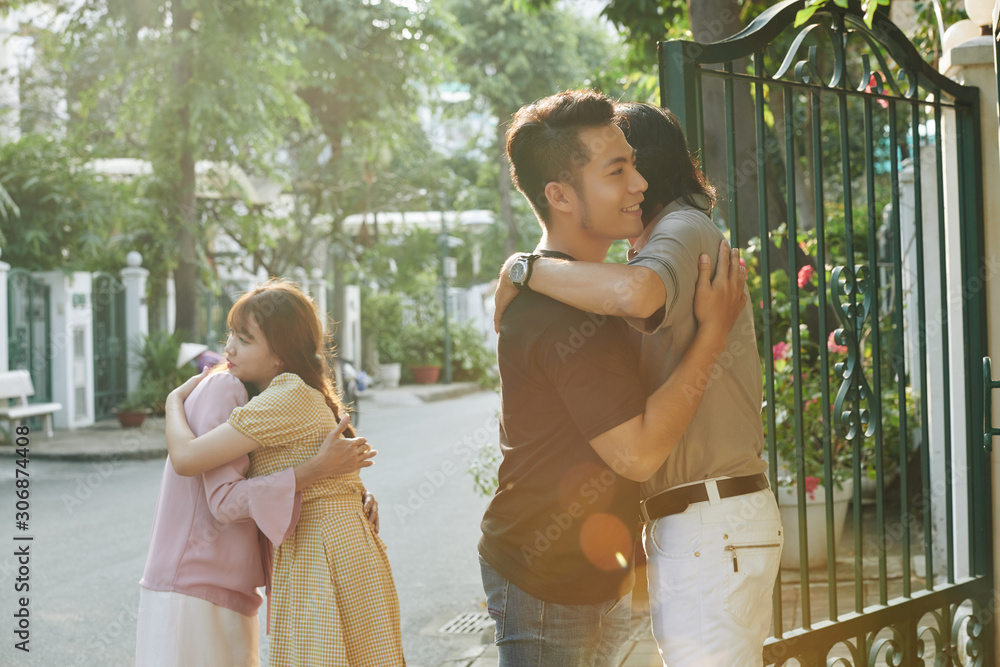 Poster vietnamese young people hugging their parents when leaving native home