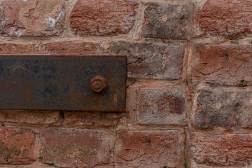 Iron rusty fasteners on an old brick wall. Background,texture, wallpaper. Copy space.