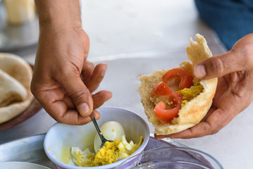 Simple and tasty food. Fresh Pita stuffed with egg and tomato, spice and olive oil.