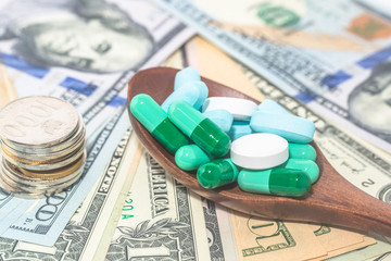 Capsules, tablets, medicines with dollars and COINS, health care, health care concept ideas