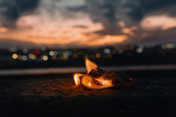 Burning piece of paper and blurred background.Bokeh effect.