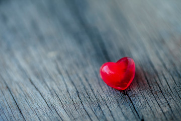 Fototapeta premium Red heart decorated on wooden table rustic background.
