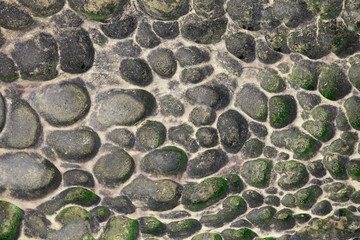 Round granite and basalt paving stones background old and antique paved street.