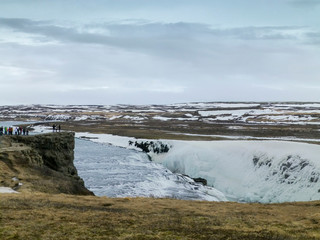 Amazing Icelandic winter landscape of majestic waterfall of frozen Gullfoss