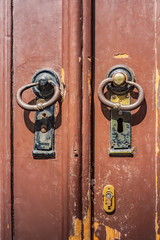 old wooden door with iron handle and keyhole