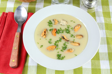 plate of mussel soup on a table
