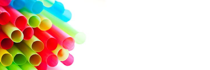 Close up of rainbow colorful drinking straws on panoramic white background