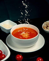 tomato soup with grated cheese and crackers