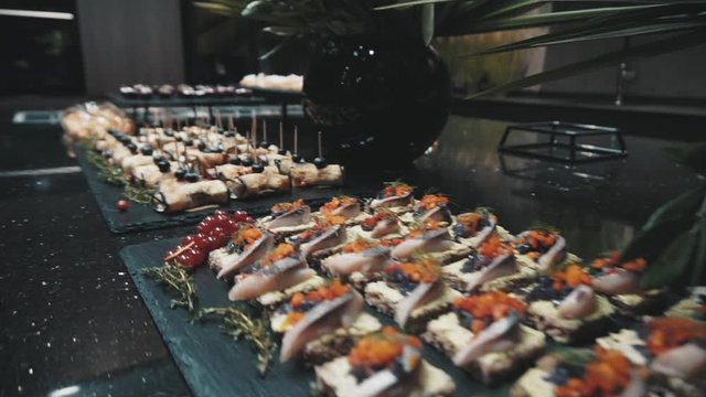 Prepared snacks and sandwiches on buffet table at fancy restaurant