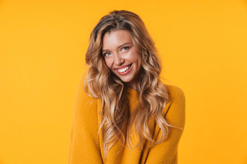Image of gorgeous blonde woman wearing warm sweater smiling at camera