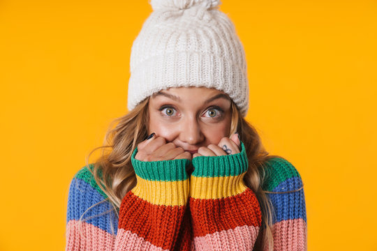 Image Of Frozen Blonde Woman In Winter Hat Staying Warm In Her Sweater