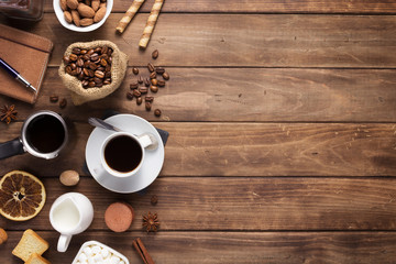 coffee beans with cup at wooden table background