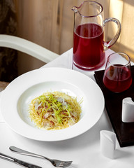 spaghetti with bacon in cream sauce and arugula