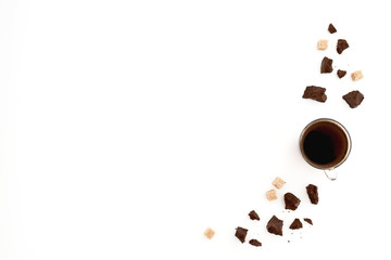 Composition with coffee cup, sugar and chocolate on white background. Flat lay, top view