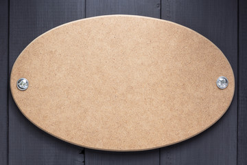 nameplate or wall sign at black wooden background texture