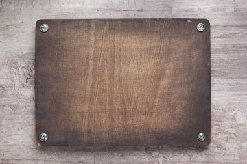 wooden nameplate or wall sign at concrete background