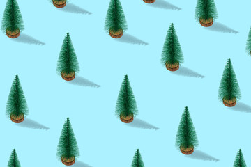 Christmas pattern. Many christmas treeson a blue background. New Year concept.