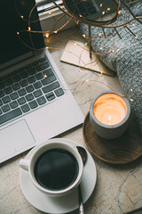 Cozy freelancer's winter work place at home with cup of coffee