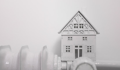 heater with house on white wall