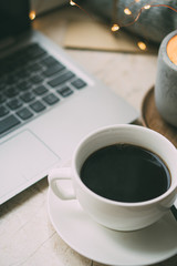 Cozy freelancer's winter work place at home with cup of coffee