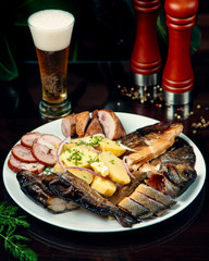 sliced smoked fish and potatoes with beer