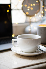 Cozy freelancer's winter work place at home with cup of coffee