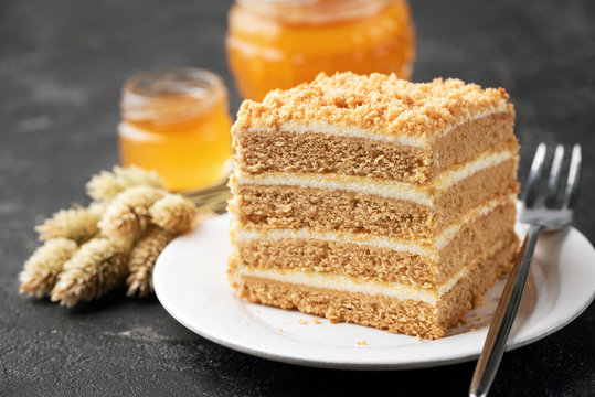 Layer Cake Medovik, Honey Cake On White Plate. Closeup View. Sponge Cake Of 4 Honey Layers With Pastry Cream