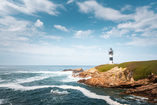 Lonely lighthouse on the coast of Galicia, Spain. Island of Pancha near Ribadeo