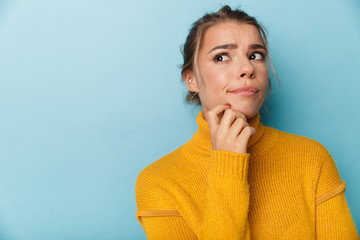 Portrait of blonde serious woman looking aside and thinking