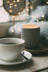 Cozy freelancer's winter work place at home with cup of coffee