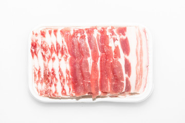Sliced pork belly on a white background