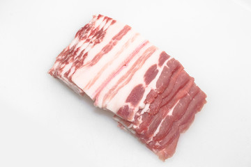 Sliced pork belly on a white background