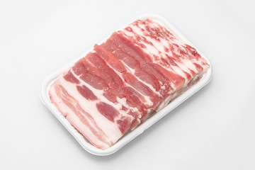 Sliced pork belly on a white background