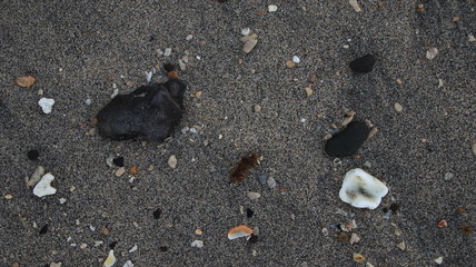 the rocks on the beach sand are gray in the morning, with less light, out of focus, suitable for the background